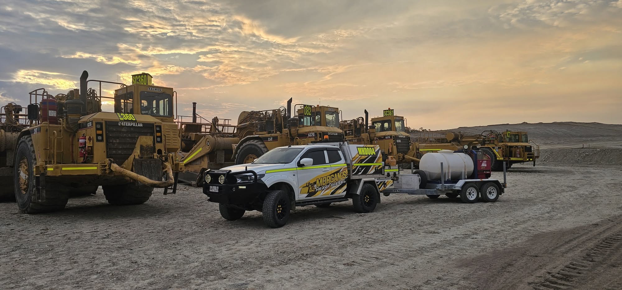 South East Queensland, CAT scraper fleet servicing at sunset, Morgan's Heavy Diesel